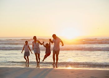 family enjoying sunset on the beach on Florida's Space Coast