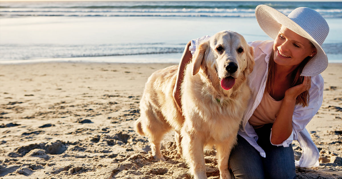 woman and dog on Florida's Space Coast Beach