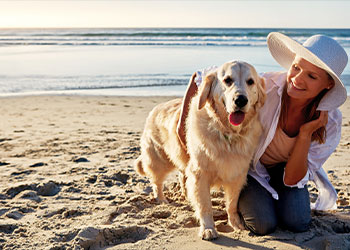 woman and dog on Florida's Space Coast Beach